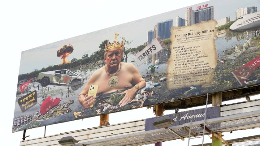 A provocative billboard featuring a satirical depiction of a man resembling Donald Trump sitting in a polluted landscape, holding a phone, wearing a crown and jewelry, surrounded by various objects including a car, a crocodile, and text referencing legislation.